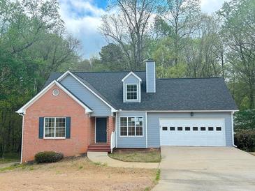 Charming single-Gathering home boasts a brick facade, two-car garage, and well-manicured lawn at 3520 Newberry Ln, Douglasville, GA 30135
