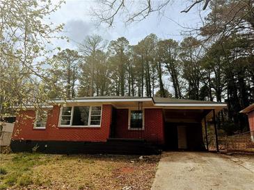 Cozy single-story brick home featuring a convenient carport and a classic, welcoming facade at 2143 Rhinehill Se Rd, Atlanta, GA 30315