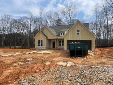 Charming home featuring attached two-car garage on spacious lot surrounded by bare trees at 270 Harmony Woods Dr, Dallas, GA 30157