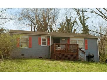 Charming single-story home featuring a cozy front porch and a well-maintained lawn at 981 Rebel Forest Se Dr, Atlanta, GA 30315