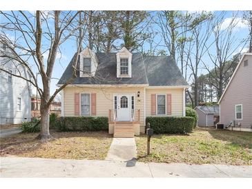 Charming bungalow-style home with dormer windows, a well-manicured yard, and a welcoming front porch at 34 Kelso At Peyton Dr, Atlanta, GA 30311