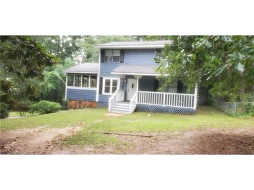Charming two-story home with blue siding, covered front porch, and mature trees at 4473 Marjorie, Snellville, GA 30039