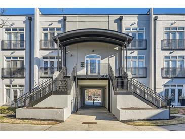 View of the building entrance with a covered entryway and black metal railings, offering a stylish welcome at 502 Pryor Sw St # 301, Atlanta, GA 30312