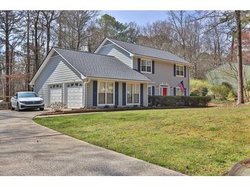 Charming two-story home with a well-manicured lawn, a two-car garage, and tasteful landscaping at 2113 N Landing Way, Marietta, GA 30066