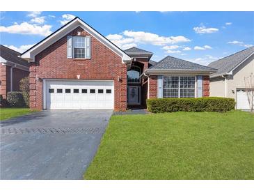 Charming brick home with well-manicured lawn, attached garage, and inviting front entrance at 2201 Chase Se Way, Conyers, GA 30013