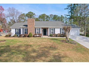 Charming single-story home with a well-maintained lawn and mature landscaping at 3285 Mitsy Forest Ne Way, Marietta, GA 30068