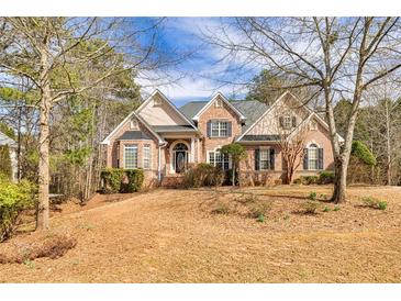 Charming brick home with well-maintained landscaping and a welcoming front entrance, perfect for curb appeal at 418 Abbey Springs Way, Mcdonough, GA 30253