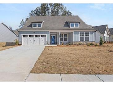 Charming single-story home with welcoming front porch, two-car garage, and well-maintained lawn at 30 Foothills Trl, Sharpsburg, GA 30277