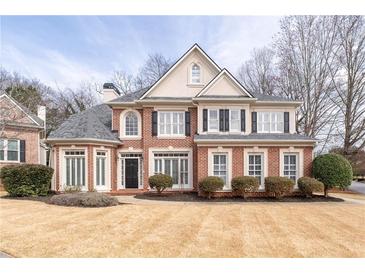 Charming two-story brick home with manicured lawn and traditional shutters at 3350 Fieldwood Se Dr, Smyrna, GA 30080