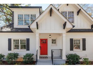 Charming home featuring a bright red front door and black shutters, complemented by meticulous landscaping and a welcoming entrance at 827 Derrydown Way, Decatur, GA 30030