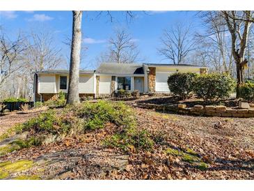 Charming single-story home with stone accents and a well-maintained front yard at 9760 Greenside Way, Douglasville, GA 30135
