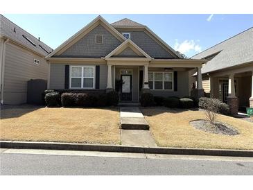 Charming one-story home featuring a manicured front yard and welcoming entrance at 317 Glens Way, Woodstock, GA 30188