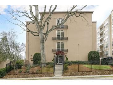 Tan building with three stories and iron balconies, landscaped with mature trees and wrought iron fence at 395 Pharr Ne Rd # 305, Atlanta, GA 30305