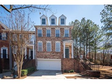 Charming brick townhome with a two-car garage and inviting curb appeal at 402 Iona Abbey Se Ct, Smyrna, GA 30082