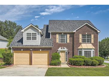 Beautiful brick two-story home with a well-manicured lawn and a two-car garage in a quiet neighborhood at 3370 Flagstone Trce, Ellenwood, GA 30294