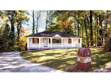 Charming single-story home with a welcoming front porch and well-manicured lawn at 610 Walnut Sw Pl, Marietta, GA 30060