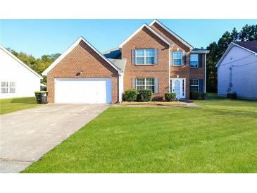 Charming two-story brick home with well-maintained lawn and attached garage at 6251 Lamp Post Pl, Atlanta, GA 30349