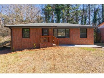 Charming brick ranch-style home featuring a well-maintained lawn and inviting entrance at 801 N Evelyn Nw, Atlanta, GA 30318