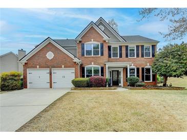 Charming brick home with a well-manicured lawn and a two-car garage, showcasing classic suburban living at 245 Davenham Ct, Alpharetta, GA 30005