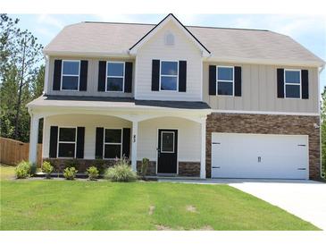 Charming two-story home with a welcoming front porch, attached garage, and well-maintained lawn at 83 Nyishol Way, Dallas, GA 30157