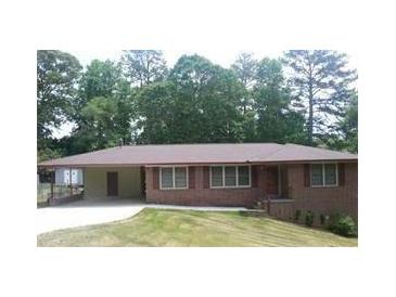 Charming single-story brick home with a carport and well-manicured front lawn at 4643 Wesley Dr, Austell, GA 30106