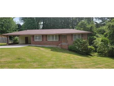 Charming one-story brick home with well-maintained lawn and covered parking at 4643 Wesley Dr, Austell, GA 30106