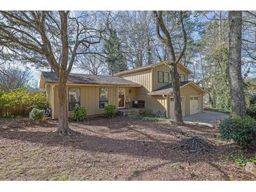 Charming home with a red door, lush landscaping, and a welcoming front porch at 4570 Nantucket Sw Dr, Lilburn, GA 30047