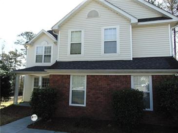 Charming two-story home featuring a combination of red brick and light siding at 1662 Maple Trace Ct, Grayson, GA 30017