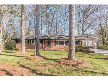 Charming brick ranch home with mature trees, green lawn, and a cozy, inviting curb appeal at 407 North Ave, Atlanta, GA 30354