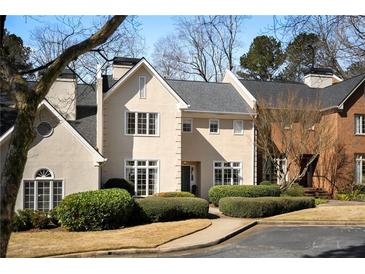 Charming two-story home with meticulously landscaped front yard and neutral color palette at 39 Paces West Nw Dr, Atlanta, GA 30327