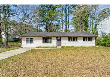 Charming single-story home featuring a well-maintained yard and a classic facade at 7613 Suwannee Ct, Jonesboro, GA 30236