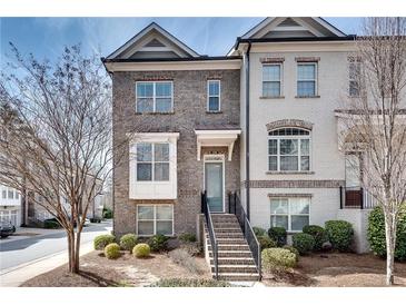 Charming brick townhome with inviting entryway and well-manicured landscaping at 145 Laurel Crest Aly, Johns Creek, GA 30024