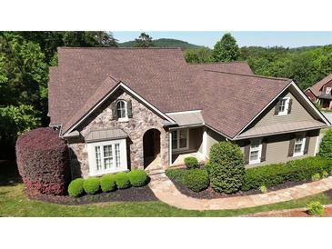 Charming home featuring a stone facade, landscaped yard, and a well-maintained lawn at 11 York Trce, Cartersville, GA 30121