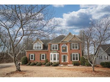 Charming two-story brick home with manicured landscaping and inviting curb appeal at 2234 Oak Falls Ln, Buford, GA 30519