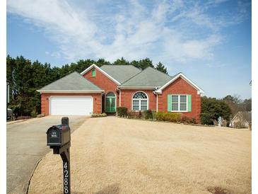 Charming brick home with well-maintained lawn, attached garage, and inviting curb appeal at 4288 Wyndham Park Cir, Decatur, GA 30034