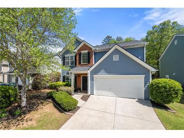 Charming two-story home with blue siding, brick accents, and a well-manicured front yard at 515 Quinn Dr, Woodstock, GA 30188