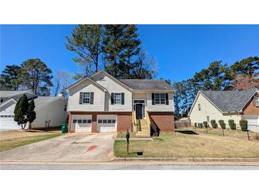 Charming two-story home featuring a well-maintained lawn, a two-car garage, and appealing curb appeal at 831 Stonebrook Dr, Lithonia, GA 30058