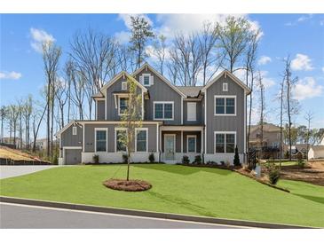 Beautiful two-story home featuring gray siding, white trim, and a well-manicured lawn at 1975 Sage Lake Bend Sw, Marietta, GA 30064