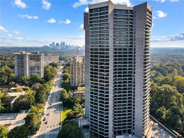 Stunning high-rise condominium showcasing city views on a beautiful day with blue skies and a lush tree canopy at 2660 Peachtree Nw Rd # 11G, Atlanta, GA 30305