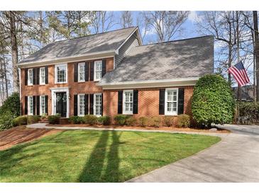 Beautiful brick home with black shutters, mature landscaping and a well maintained lawn at 4165 Liberty Trce, Marietta, GA 30066