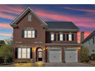 Beautiful two-story brick home featuring a two-car garage and well-maintained landscaping at 586 Shoal Mill Sw Rd, Smyrna, GA 30082