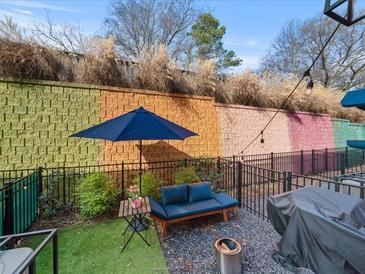 Private patio with outdoor seating, vibrant wall art, and stylish decor at 166 Color Cir, Atlanta, GA 30317