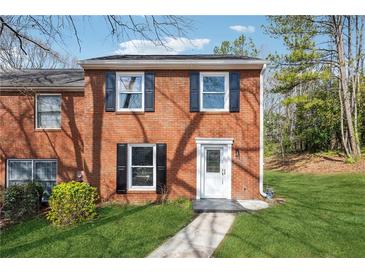 Charming brick two-story home with black shutters and a well-manicured front yard at 185 Willow Stream Ct, Roswell, GA 30076