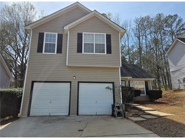 Two story home featuring an attached two car garage, black shutters, and a driveway at 4183 Ward Lake Trl, Ellenwood, GA 30294