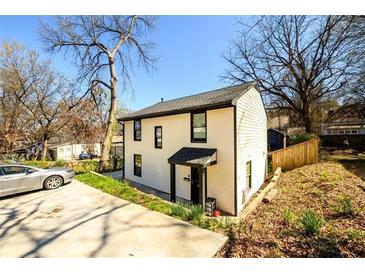 Charming two-story home with a well-manicured lawn and a private driveway at 1051 Curran Nw St, Atlanta, GA 30318