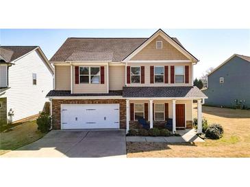 Charming two-story home features a two-car garage and a welcoming front porch with stone accents at 117 Cottage Nw Walk, Cartersville, GA 30121