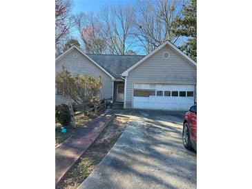 Charming single-story home with a driveway and a garage at 470 Yearling Dr, Loganville, GA 30052