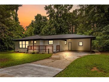 Charming brick home featuring a spacious carport and welcoming front porch at 2403 Dawn Dr, Decatur, GA 30032