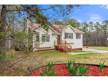 Charming single-story home featuring a cozy front porch and well-maintained landscaping at 370 Burton Dr, Douglasville, GA 30134