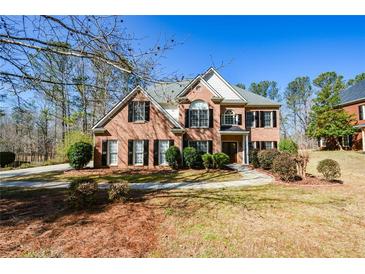 Charming two-story brick home with manicured landscaping and a welcoming front entrance at 305 Collegiate Dr, Powder Springs, GA 30127